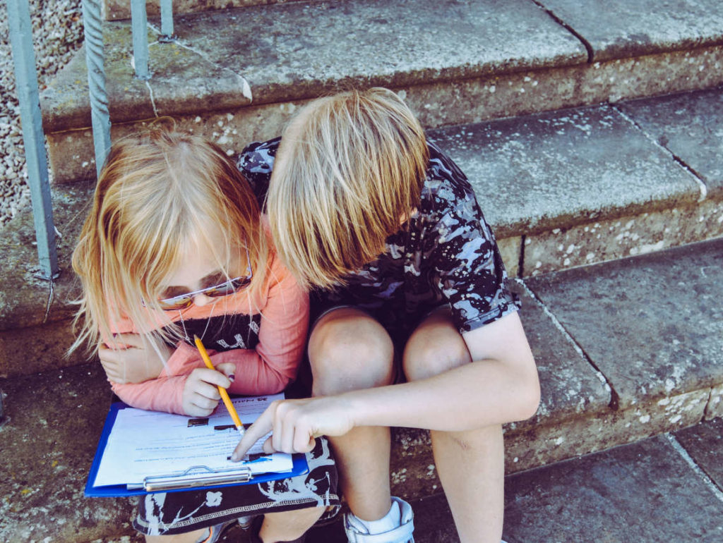 Two young children reading together